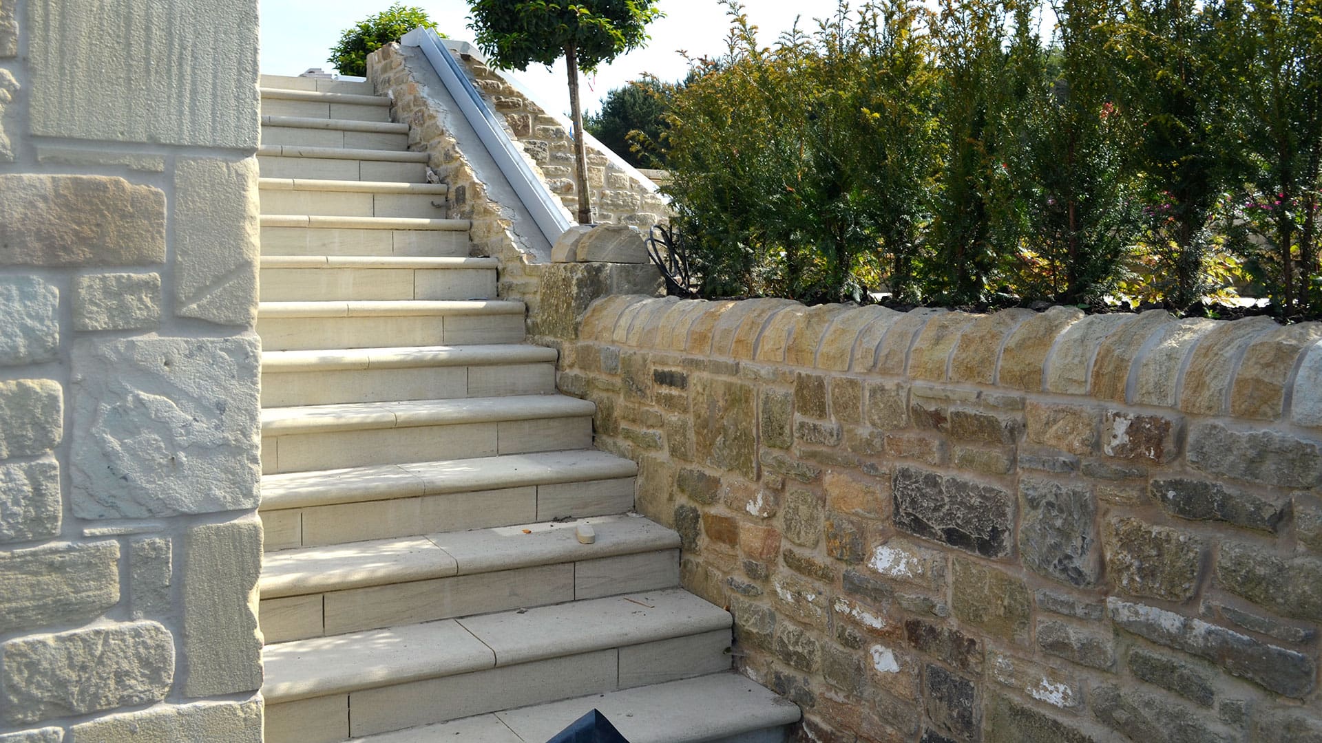 Close-up of a mortared stone wall showcasing neatly stacked stones bound together with mortar for added strength and stability.
