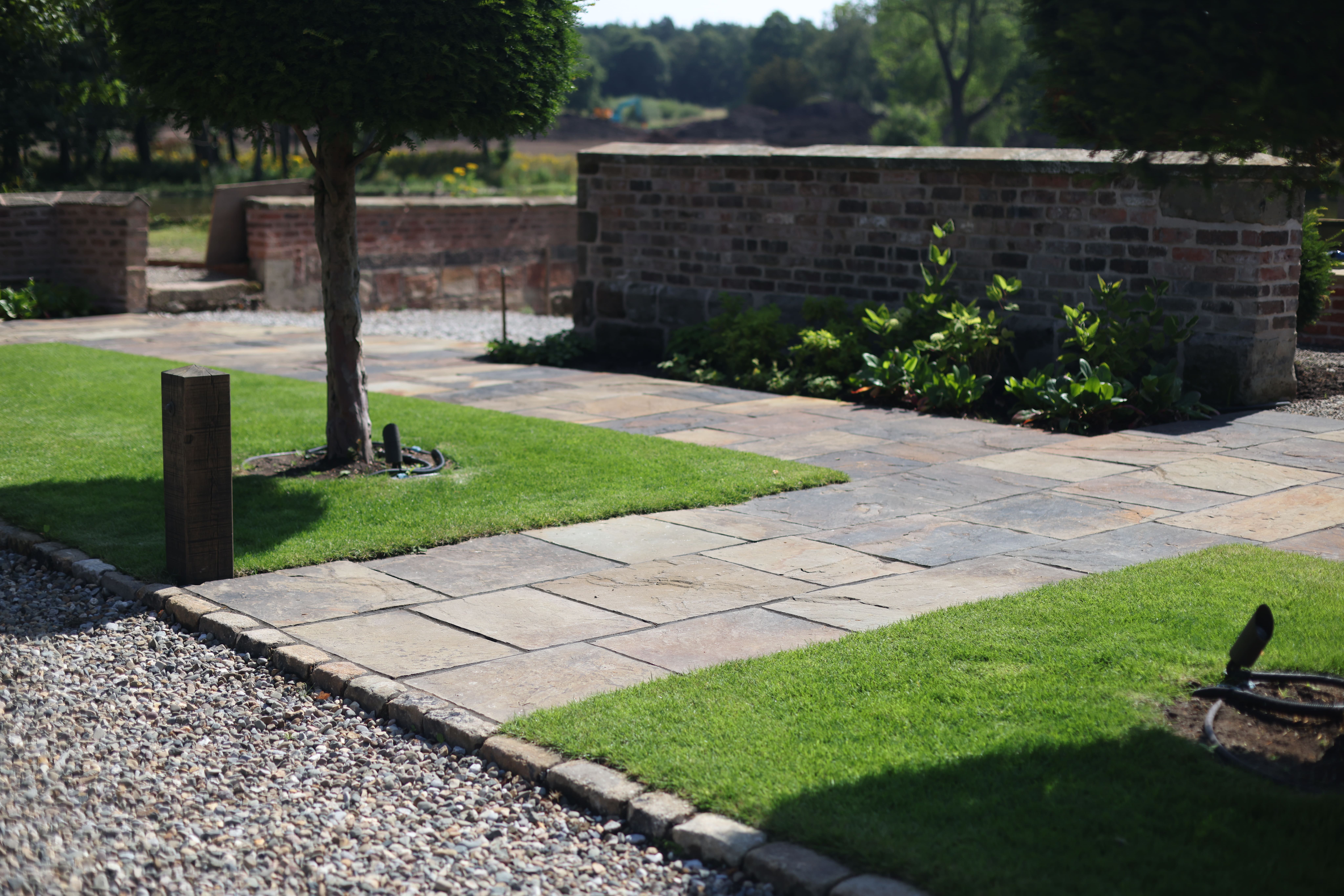 Lyons Stonework installing British riven paving, creating natural and textured surfaces for patios and walkways.