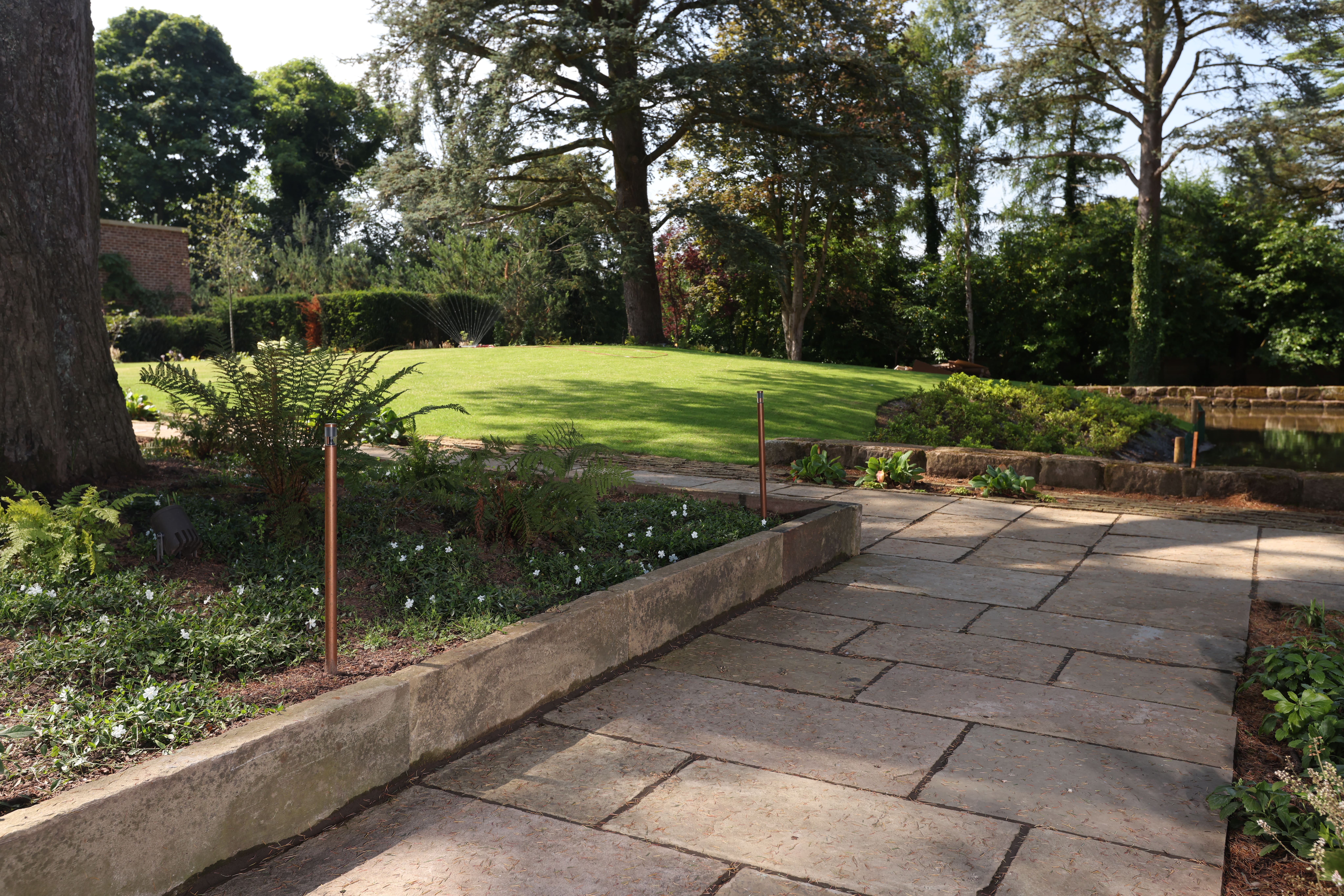 Lyons Stonework laying British riven paving, providing a natural, rustic look for patios and pathways.